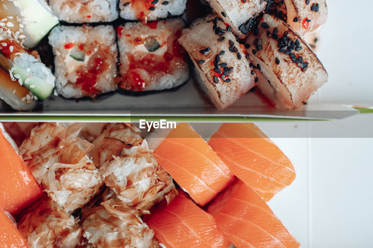 food and drink, food, seafood, freshness, cuisine, sushi, healthy eating, rice, japanese food, dish, fish, wellbeing, asian food, indoors, no people, still life, culture, high angle view, meal, raw food, salmon, close-up, california roll, variation, plate, japanese cuisine, serving size, animal, slice, meat