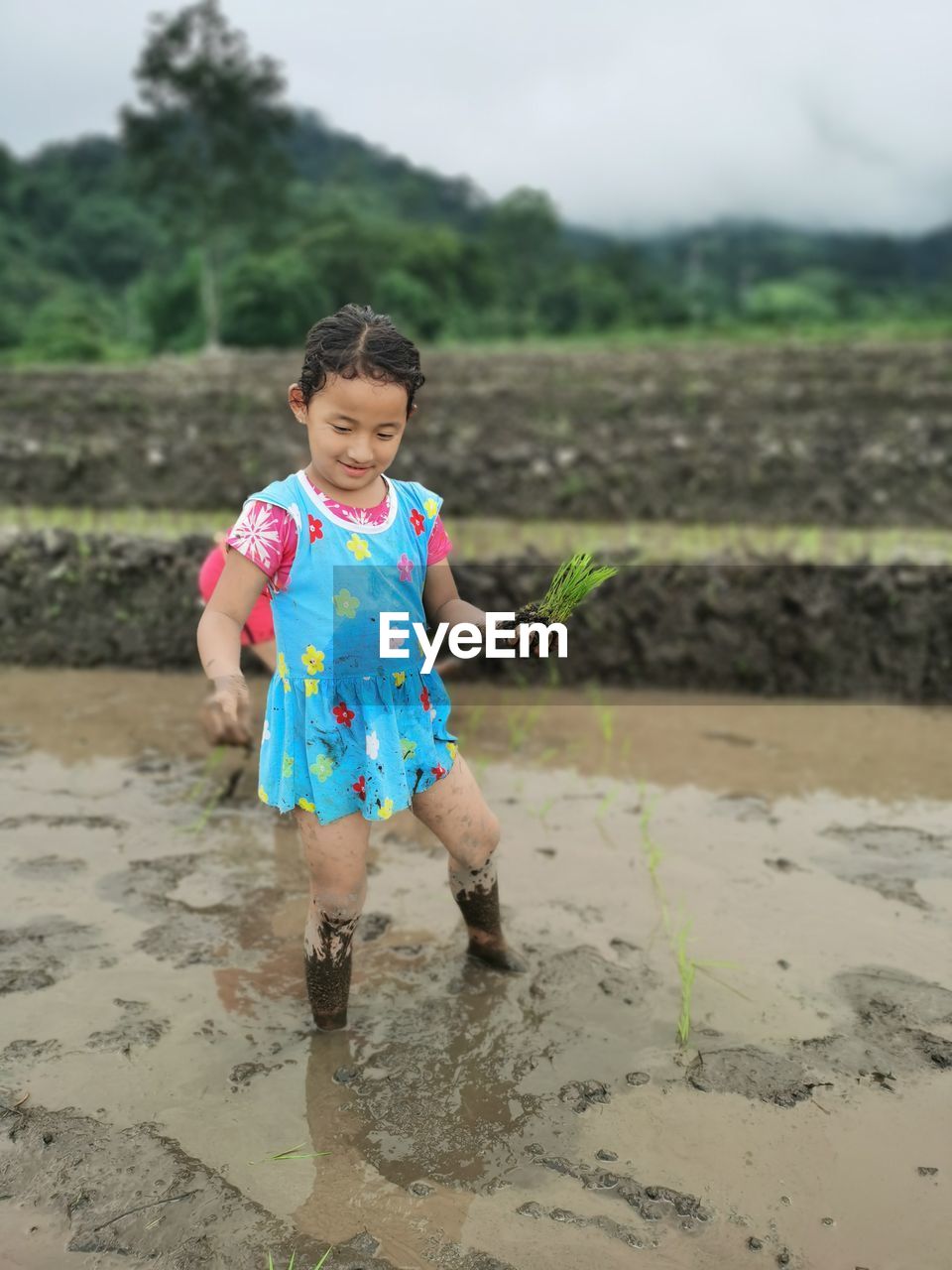 childhood, child, one person, full length, beach, nature, land, front view, happiness, sky, water, smiling, emotion, female, cute, person, casual clothing, innocence, sea, outdoors, sand, day, dirt, clothing, men, leisure activity, portrait, holding, women, lifestyles, toddler, spring, environment, mud, standing, looking at camera