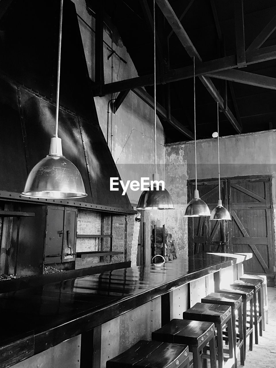 Lighting equipment hanging over table at restaurant