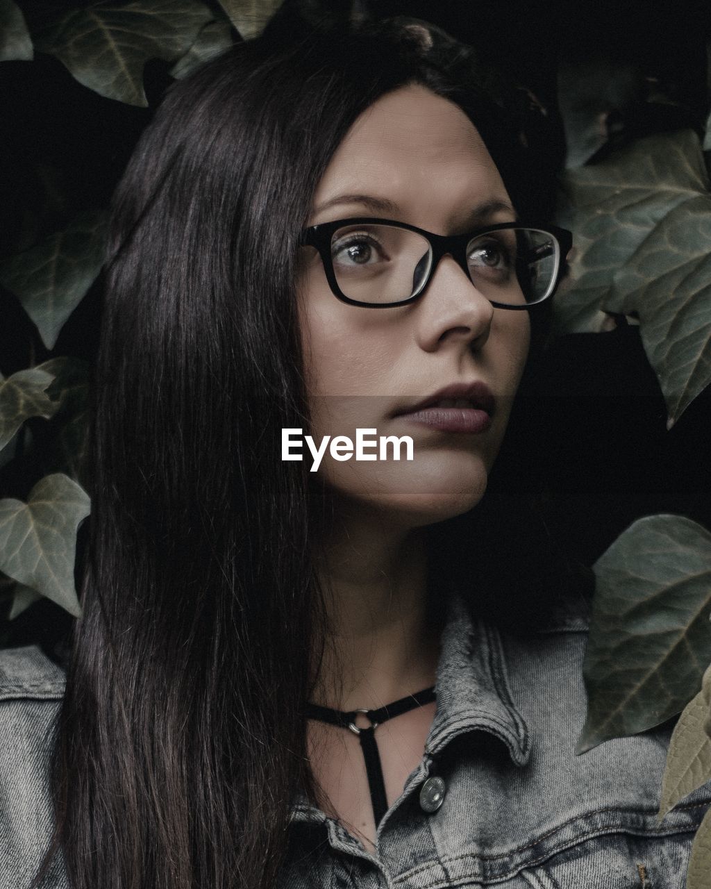Young woman in eyeglasses looking away
