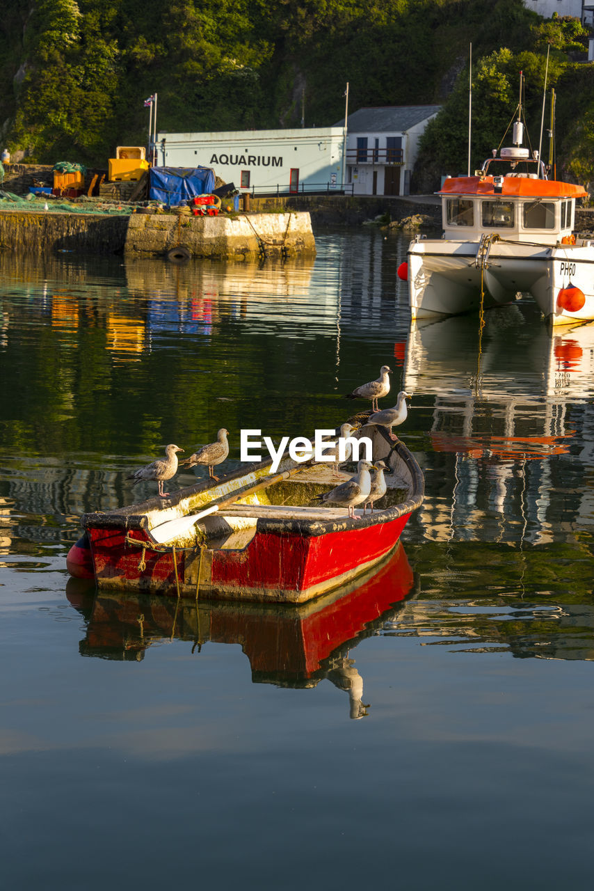 BOATS MOORED ON LAKE