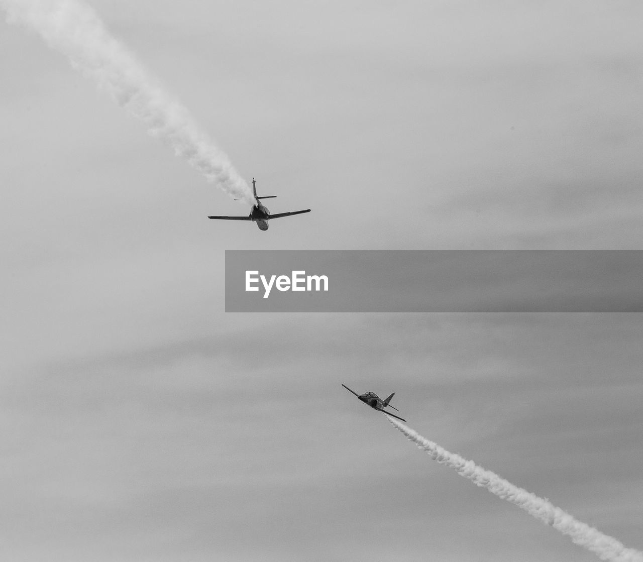 Low angle view of airplane in flight against sky