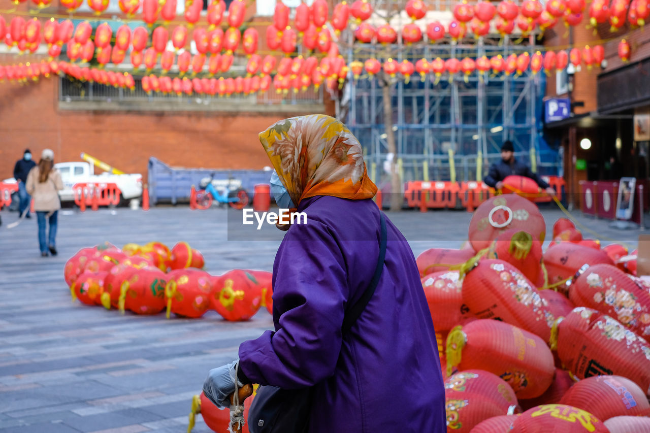 Rear view of lady with chat and scarf  at chinatown 