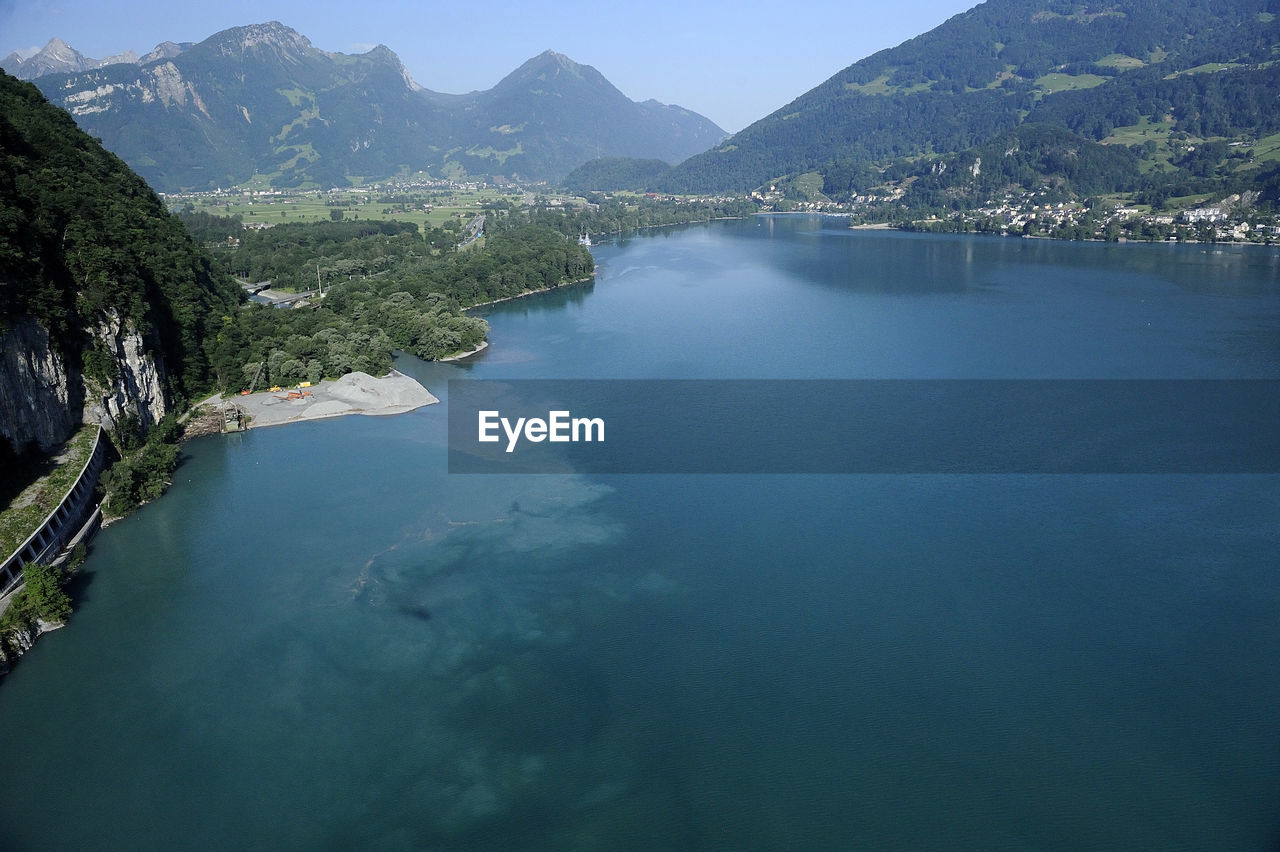 Scenic view of lake and mountains against sky