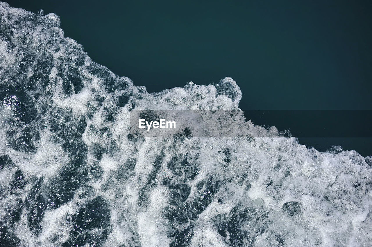 Close-up of waves on sea against sky