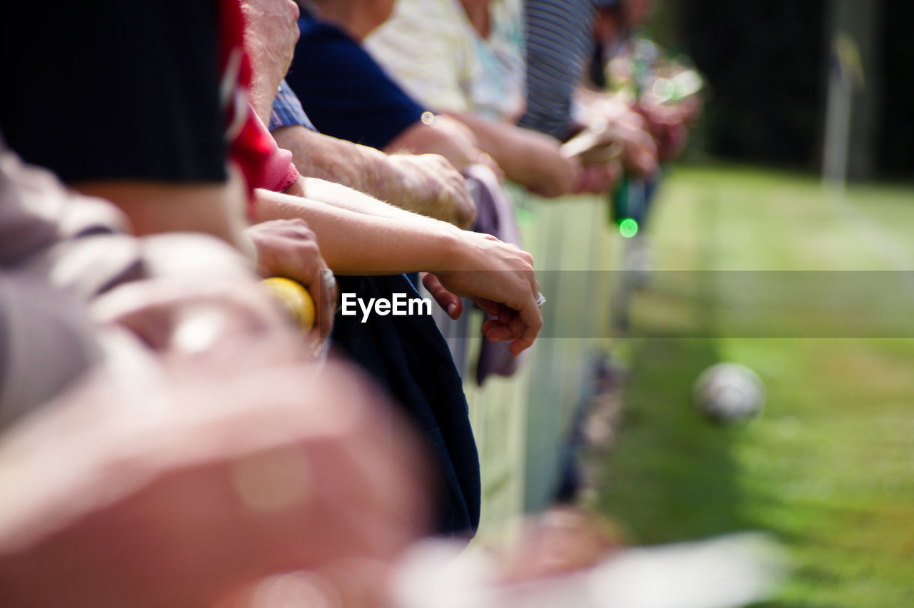 PEOPLE PLAYING WITH BALL IN GRASS