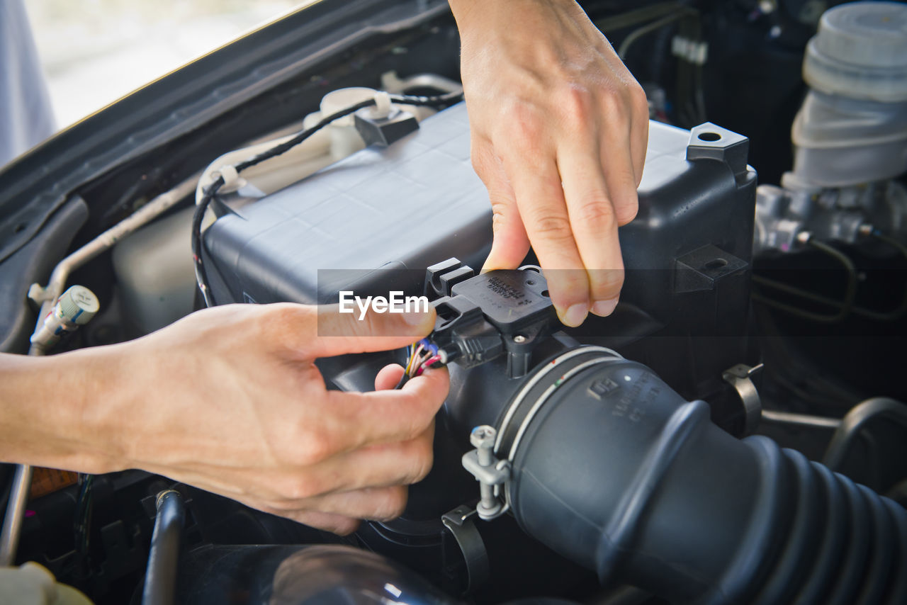 Auto mechanic checking car engine,worker selective focus