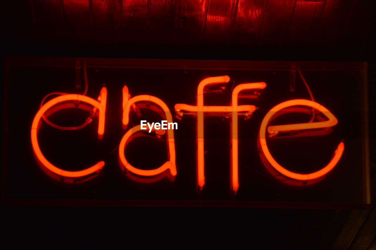 Low angle view of illuminated text at cafe