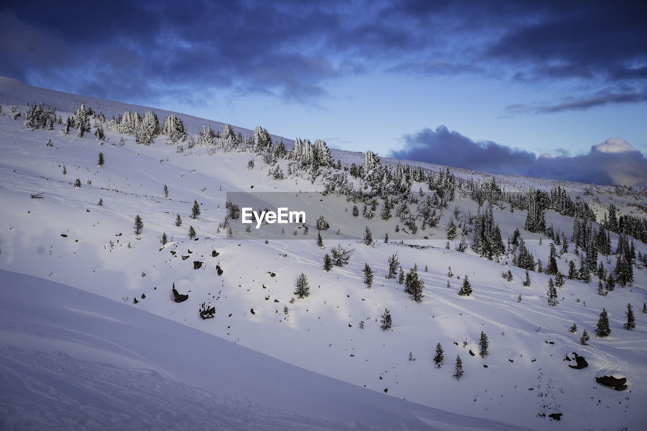 Scenic view of mountains against sky during winter