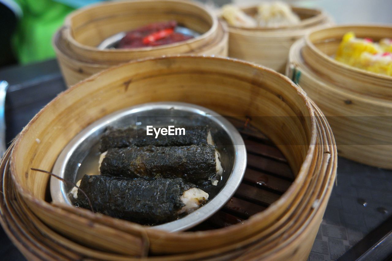 High angle view of dim sum in wooden bowl on table