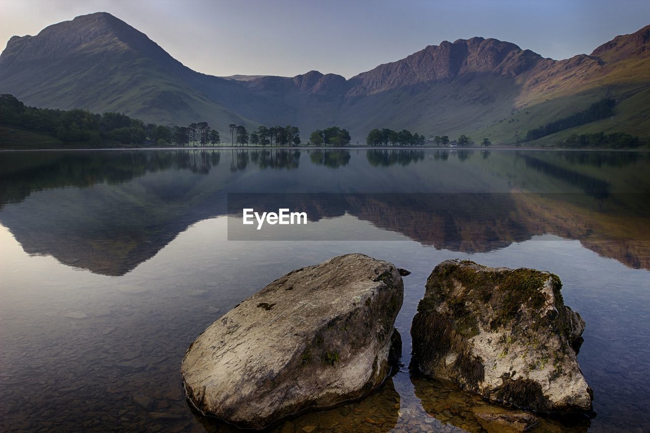 Scenic view of lake and mountains against sky