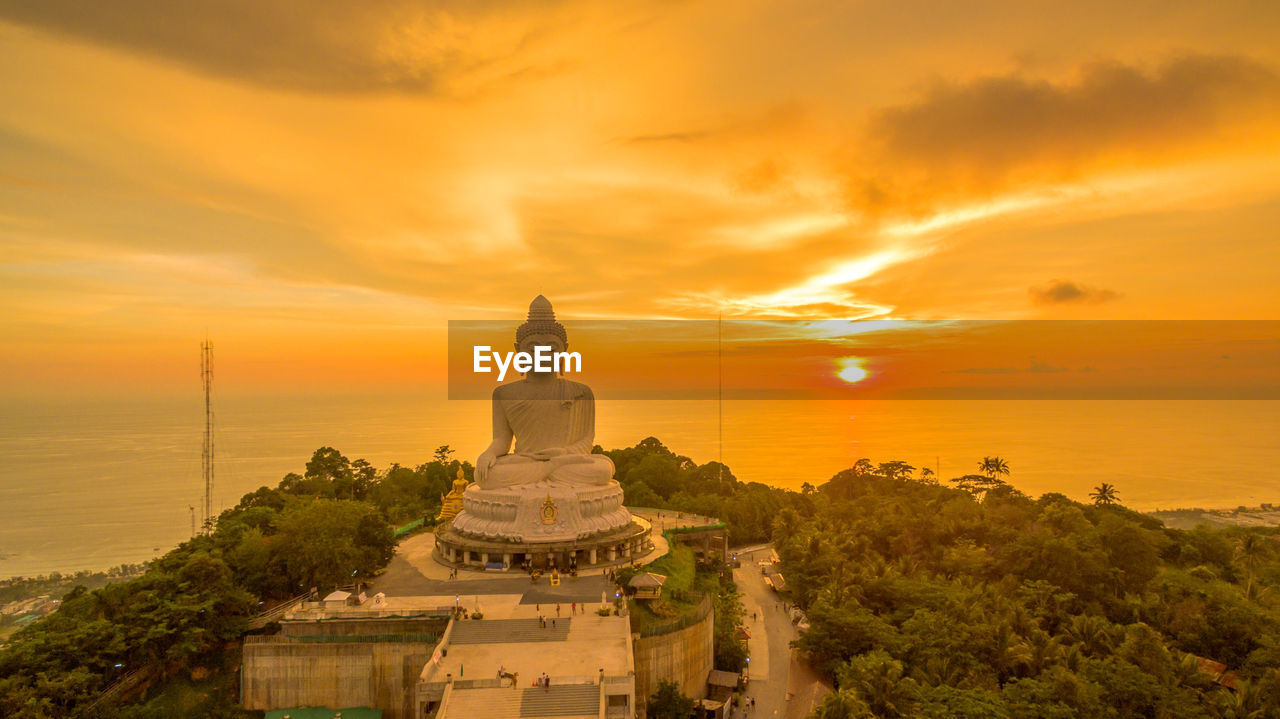 TEMPLE AGAINST BUILDING DURING SUNSET