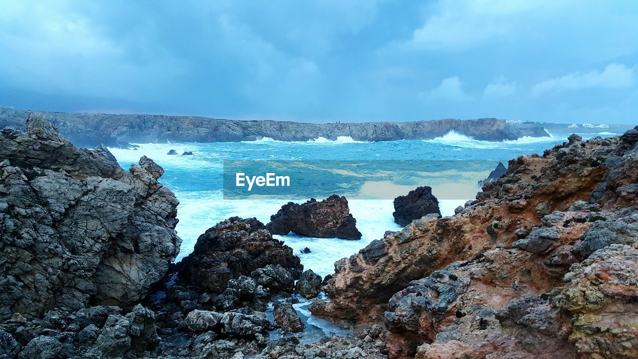 Scenic view of sea and rock formations against sky