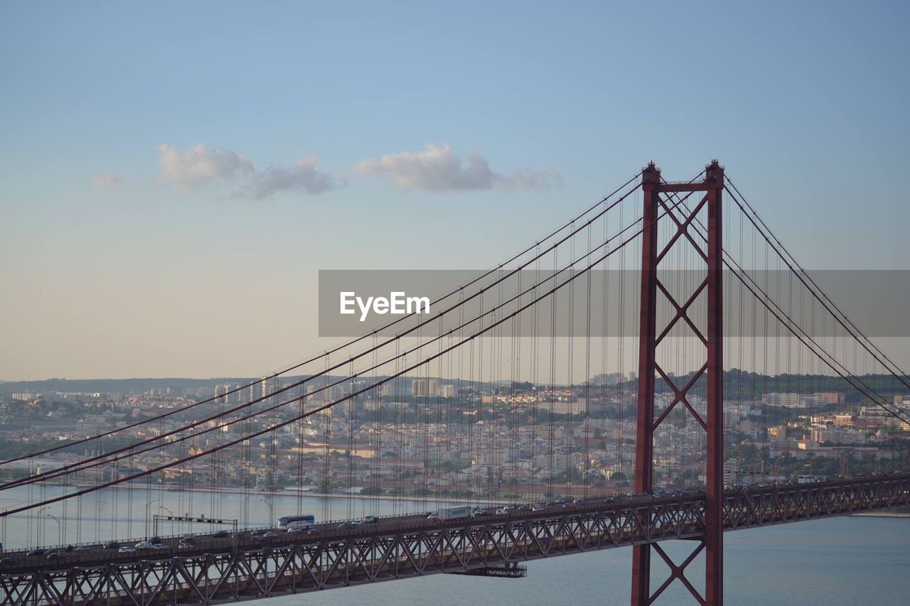 Suspension bridge over sea against sky