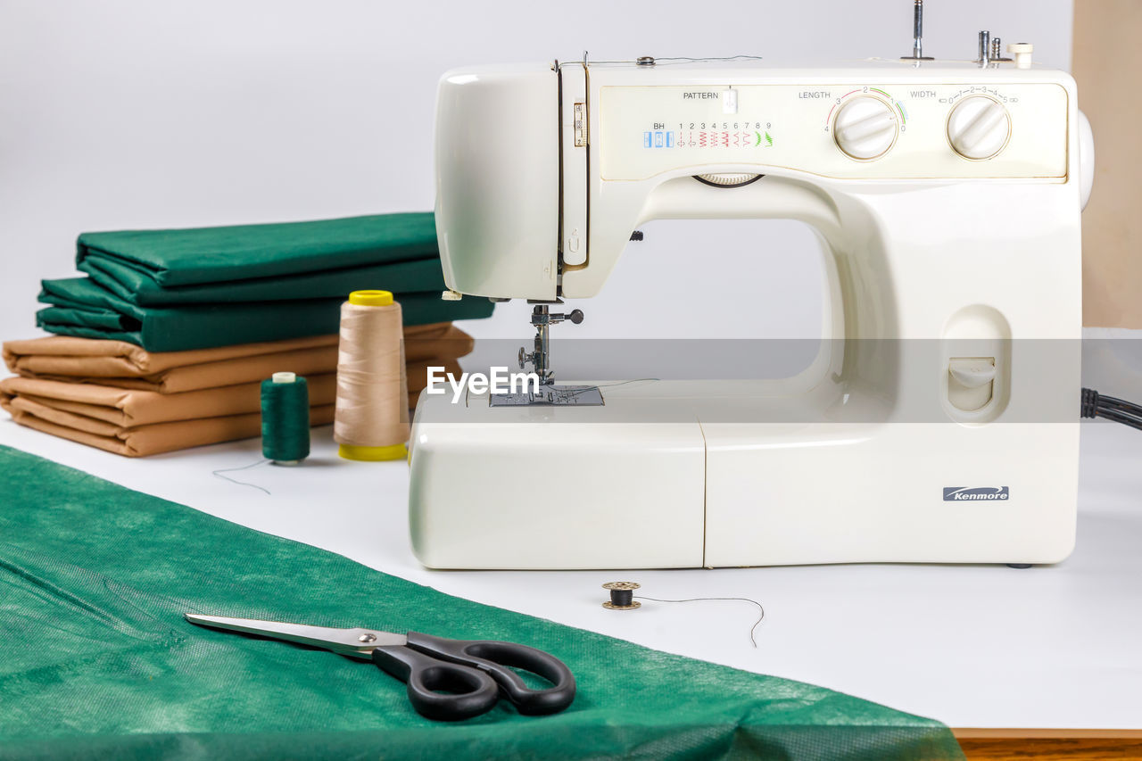 sewing machine, sewing, home appliance, art, textile, indoors, equipment, needle, thread, technology, industry, machinery, healthcare and medicine, sewing needle, occupation, manufacturing equipment, fashion