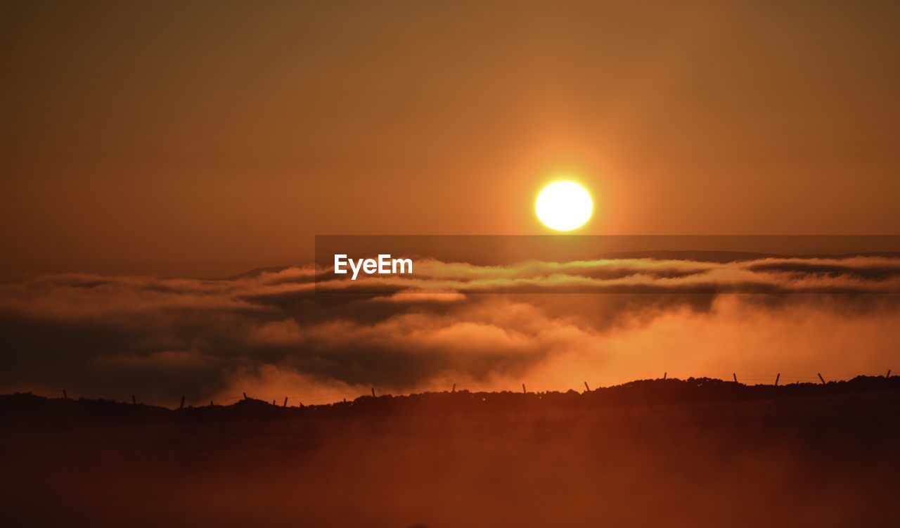 Scenic view of dramatic sky during sunset