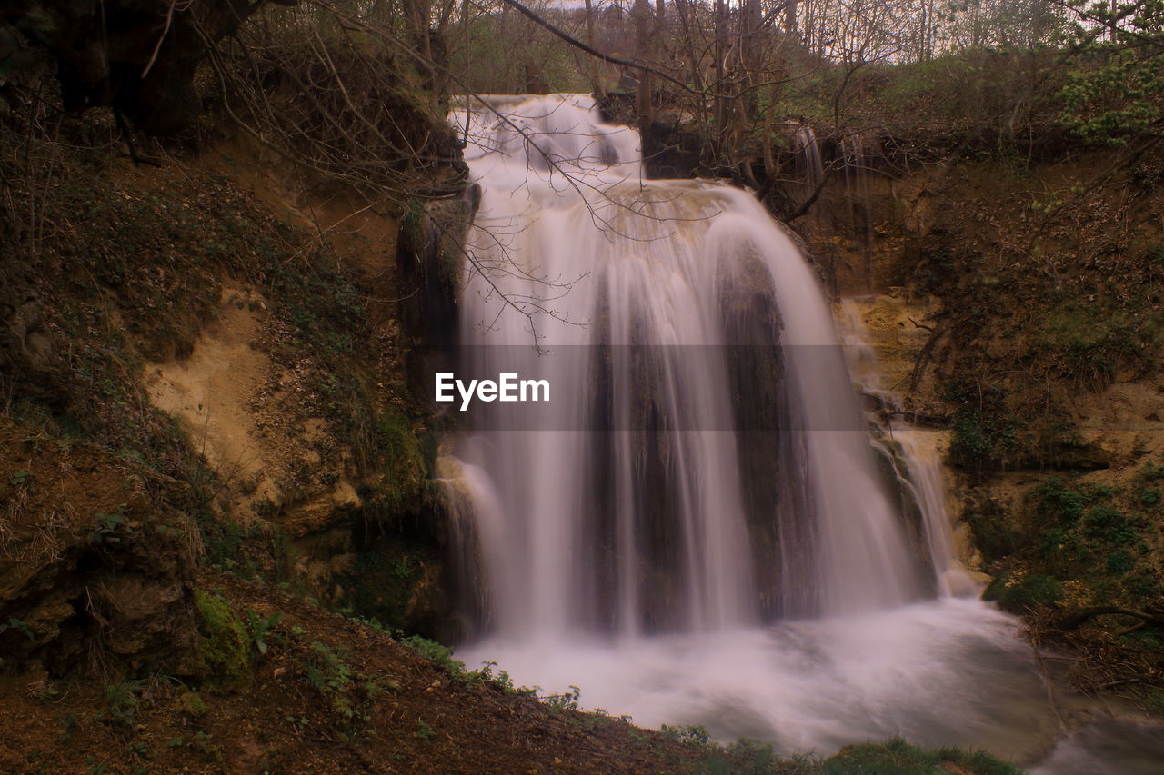 waterfall, water, scenics - nature, beauty in nature, environment, tree, nature, body of water, motion, plant, long exposure, land, water feature, forest, travel destinations, rock, tourism, flowing water, travel, no people, landscape, outdoors, non-urban scene, flowing, river, autumn, holiday, stream, fog, blurred motion, vacation, trip, environmental conservation, falling, watercourse