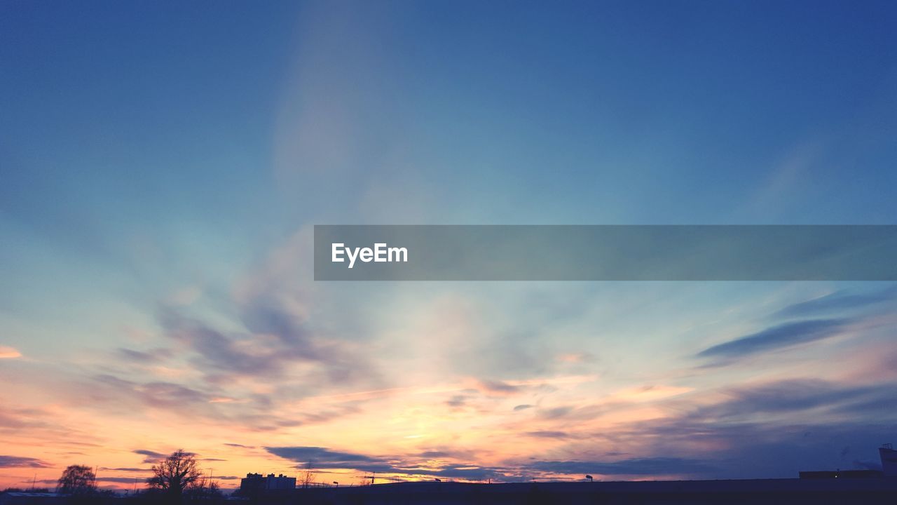 LOW ANGLE VIEW OF DRAMATIC SKY OVER SILHOUETTE LANDSCAPE