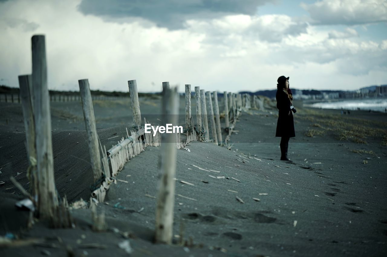 Woman standing outdoors against sky