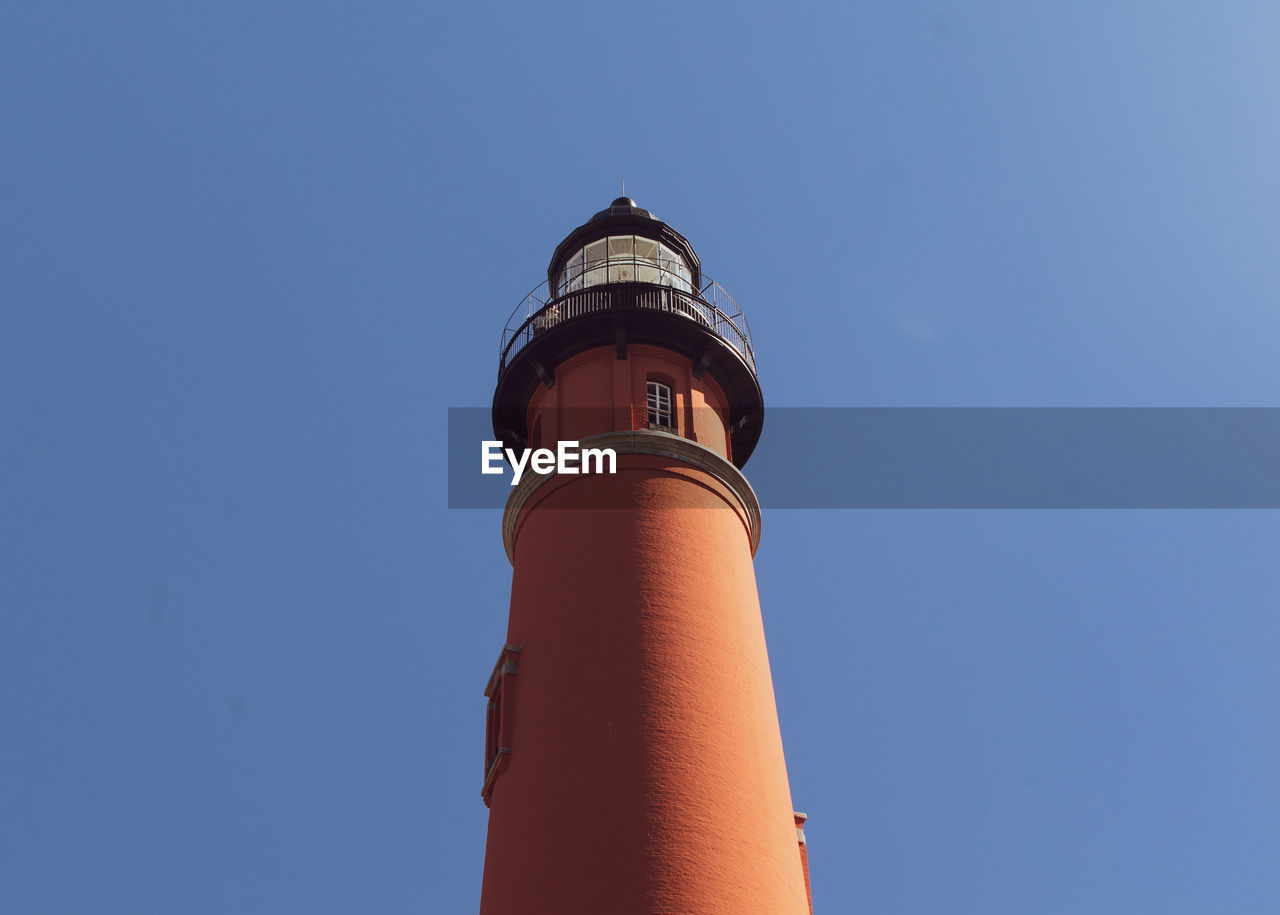 LOW ANGLE VIEW OF LIGHTHOUSE BY BUILDING AGAINST SKY