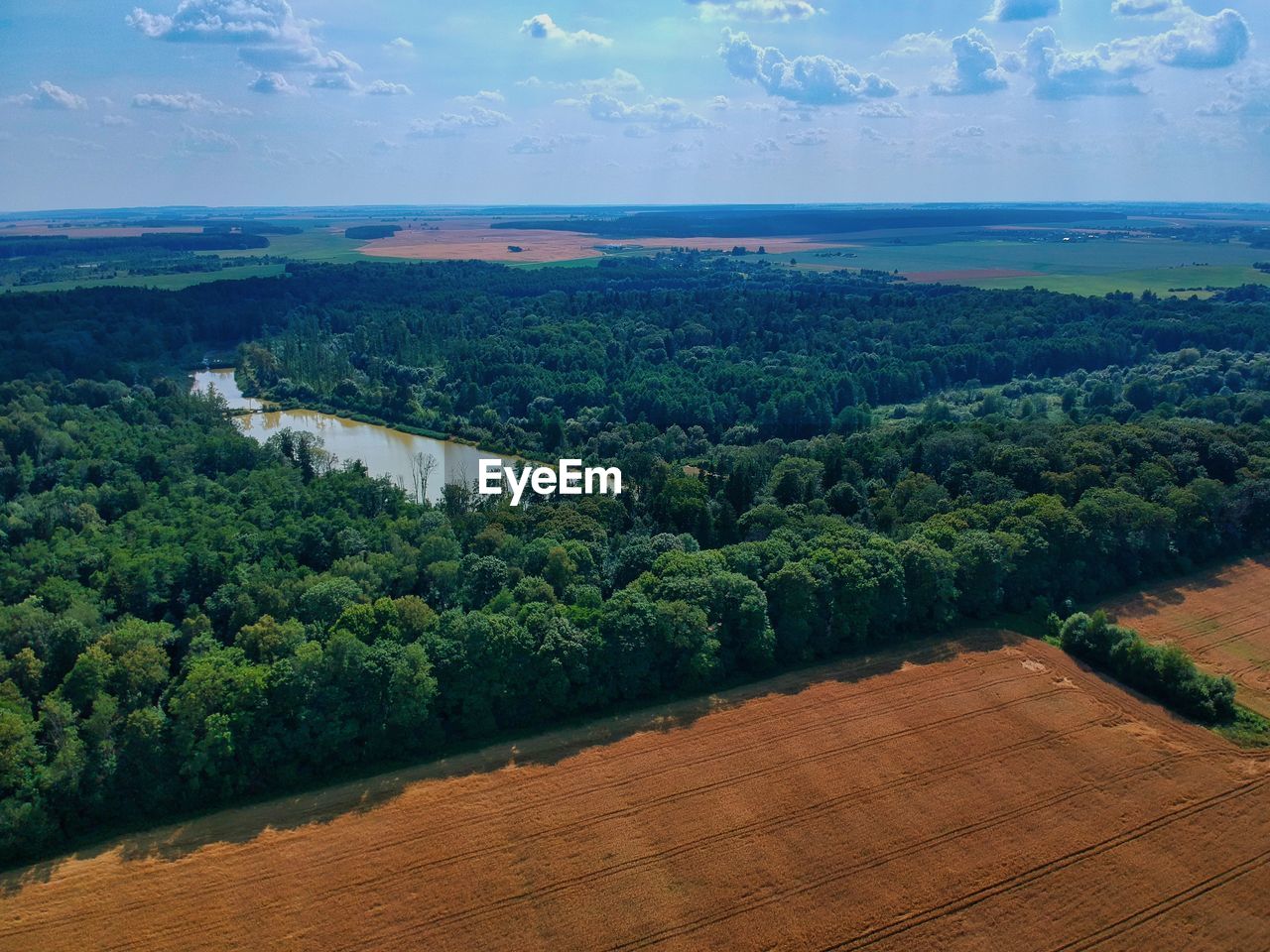 HIGH ANGLE VIEW OF FARM AGAINST SKY