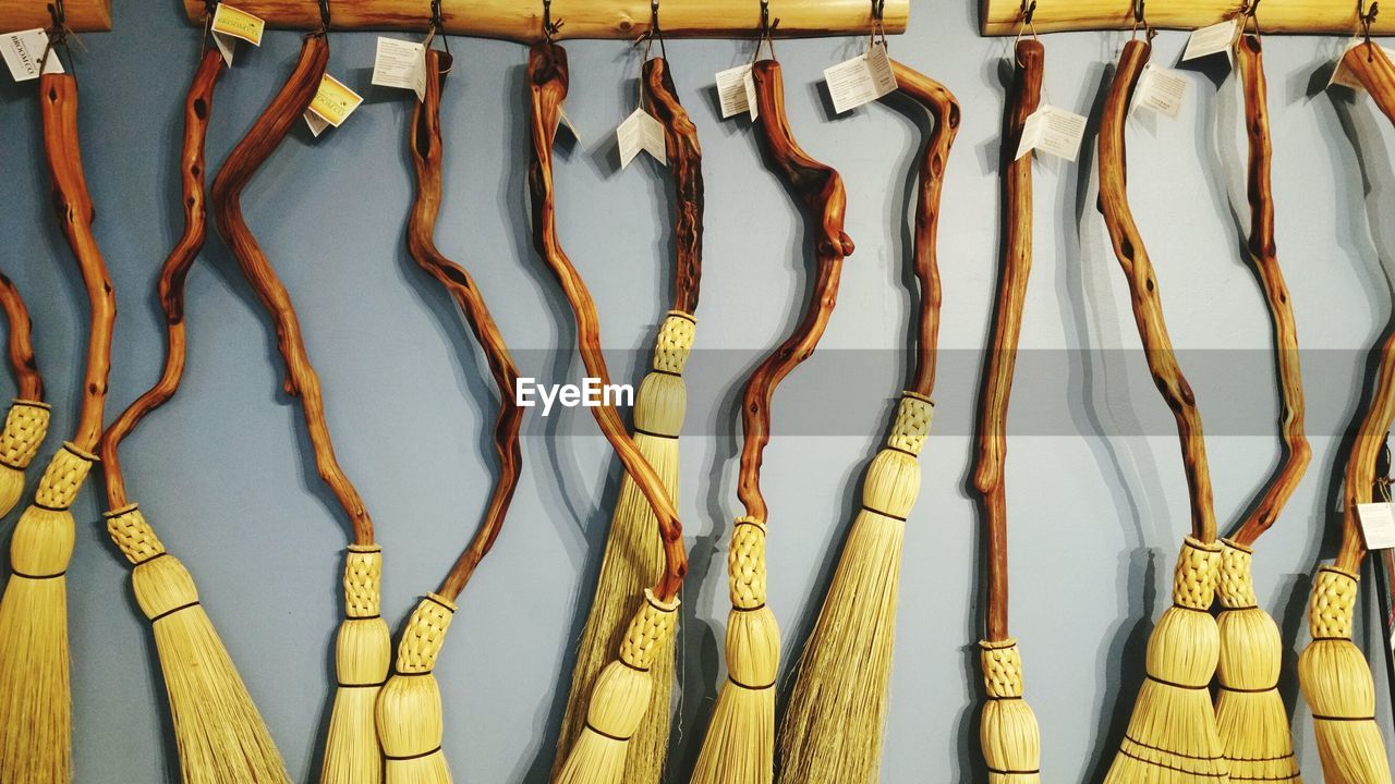 Brooms hanging on wall