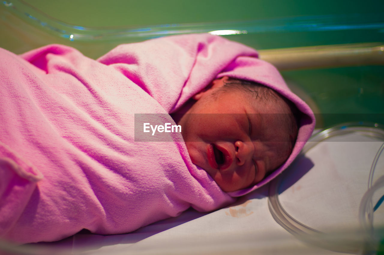 CLOSE-UP OF CUTE BABY SLEEPING IN PINK