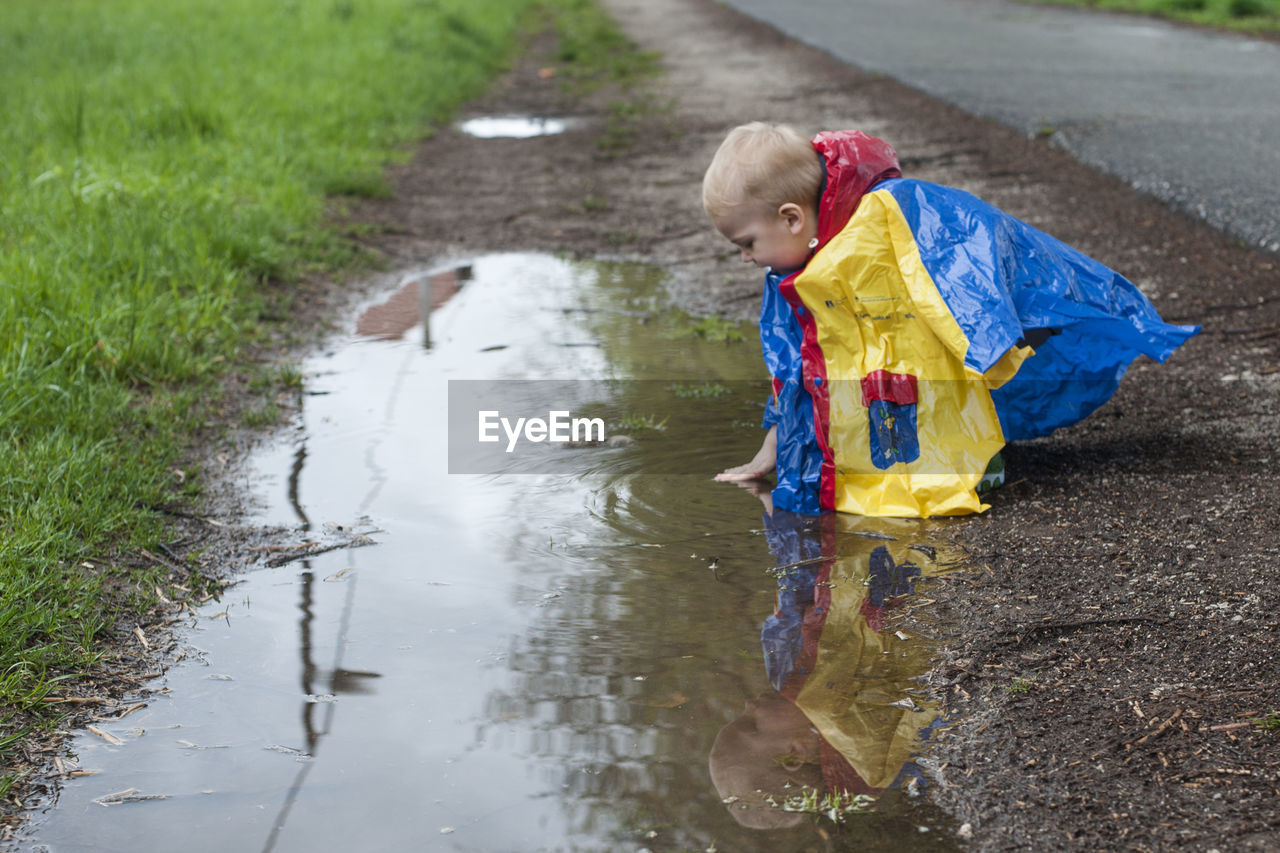 Boy playing in the puddle