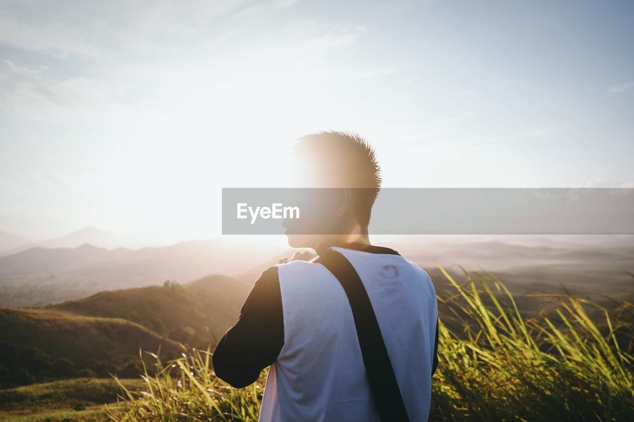 Man looking at mountain landscape