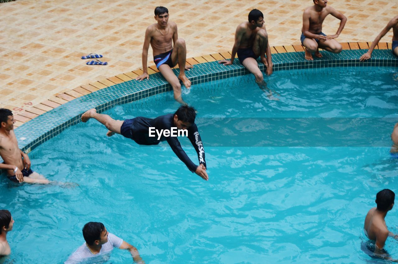 High angle view of men swimming in pool