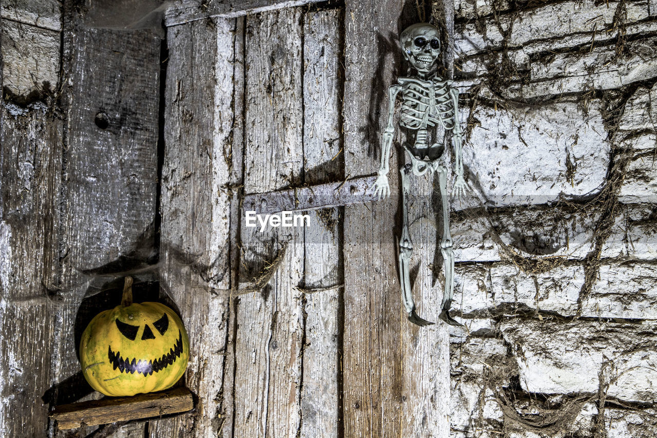 wall, no people, wood, door, wall - building feature, day, entrance, built structure, architecture, outdoors, old, close-up, textured, yellow, representation, weathered, building exterior, anthropomorphic face, face