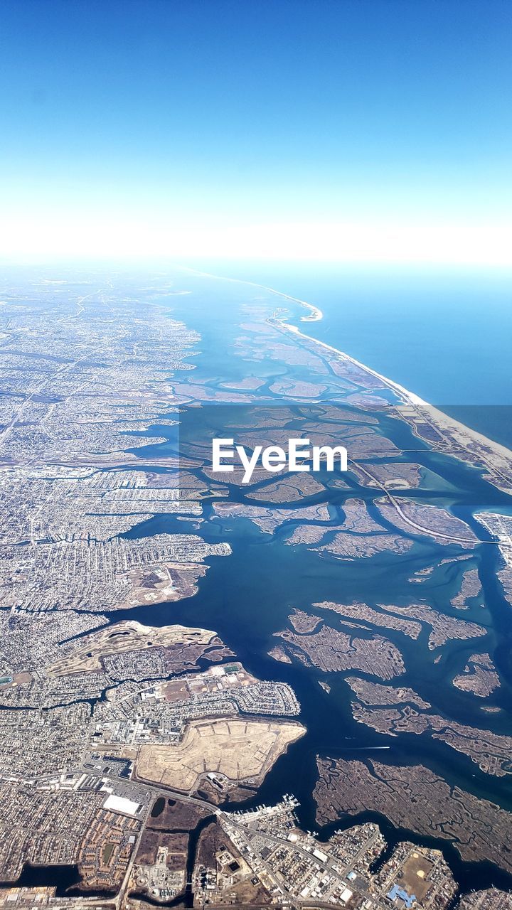 Aerial view of sea against clear sky