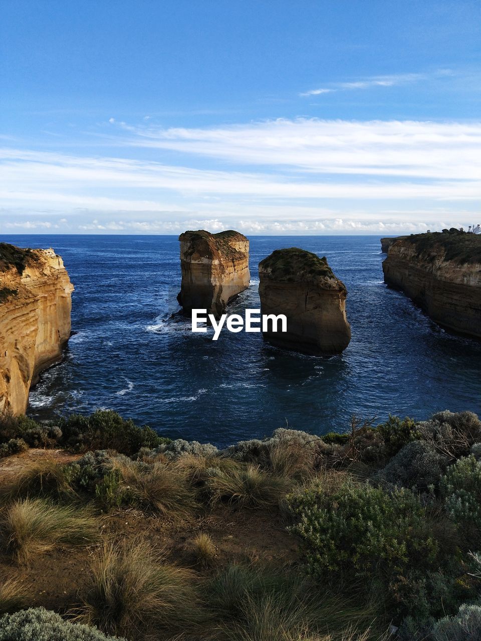 Rocks in sea against sky