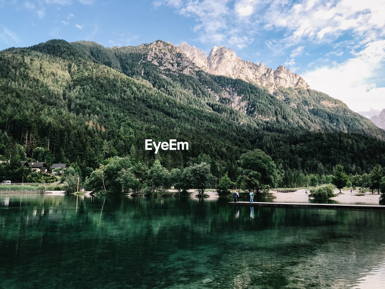 Scenic view of lake and mountains against sky