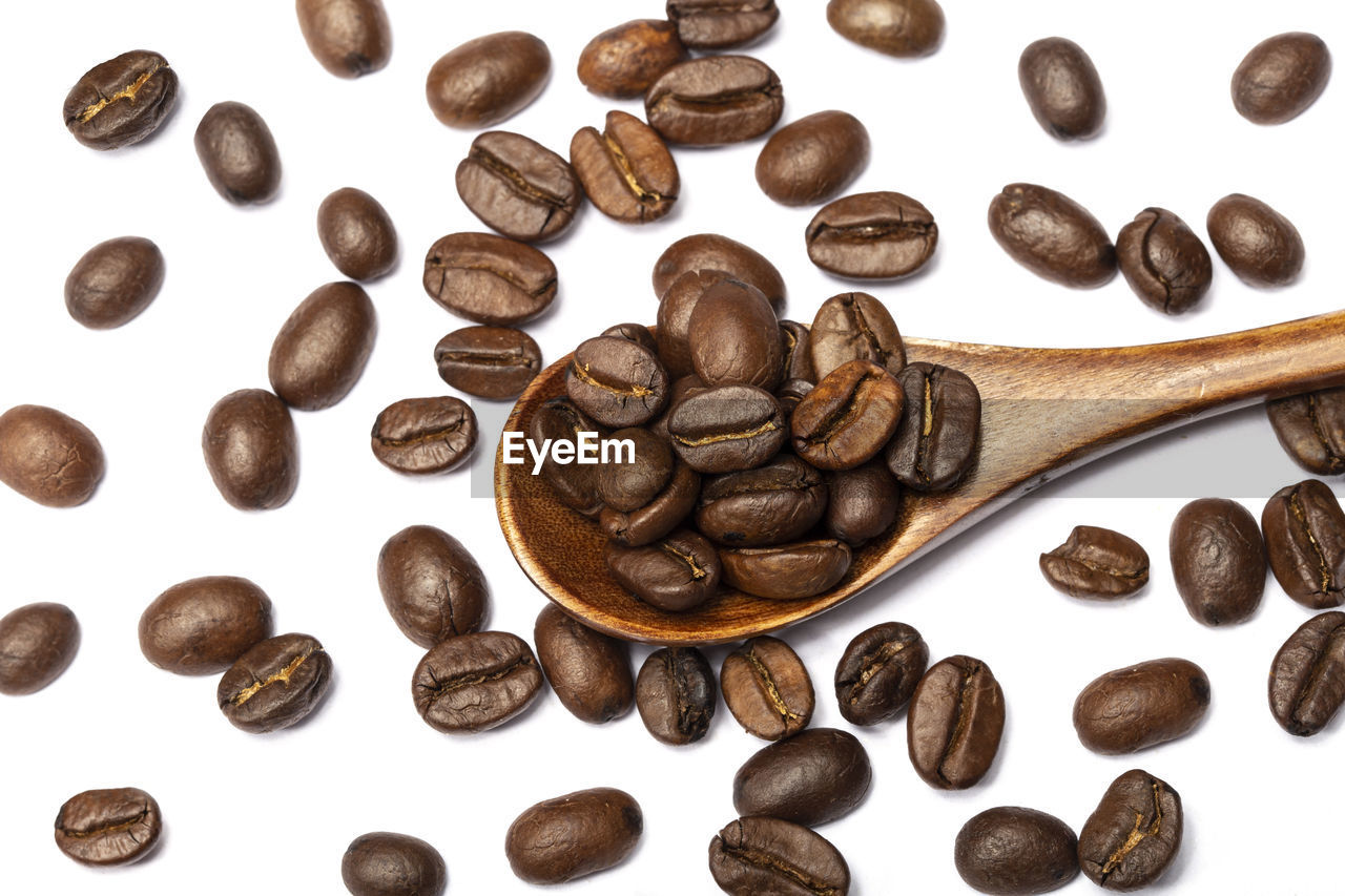 HIGH ANGLE VIEW OF COFFEE BEANS AND WHITE BACKGROUND