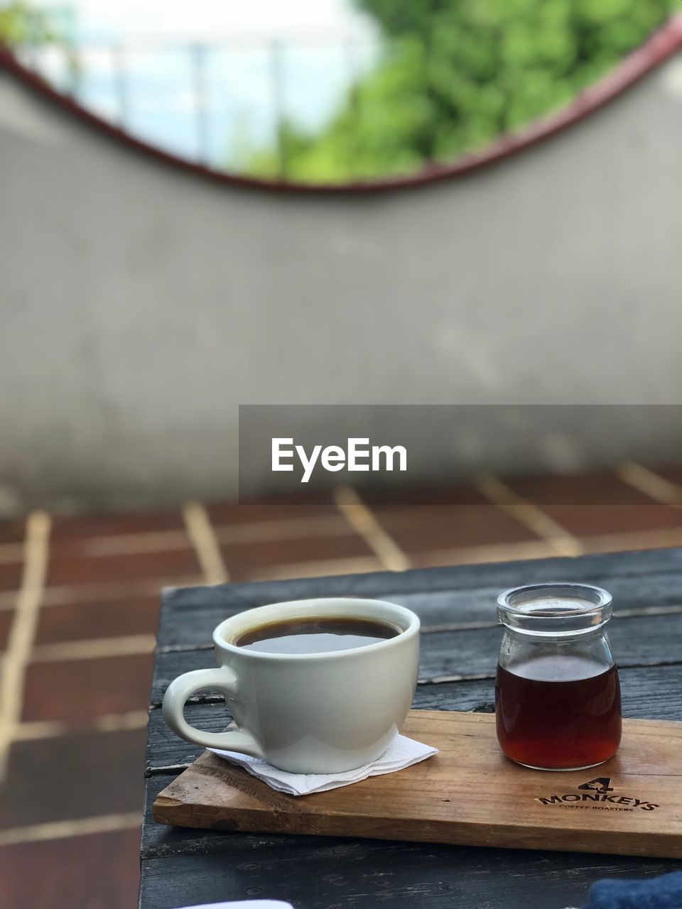 CLOSE-UP OF COFFEE CUP AND TABLE