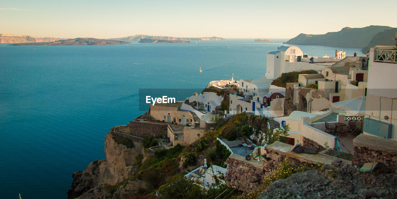 Classical whitewashed buildings by sea