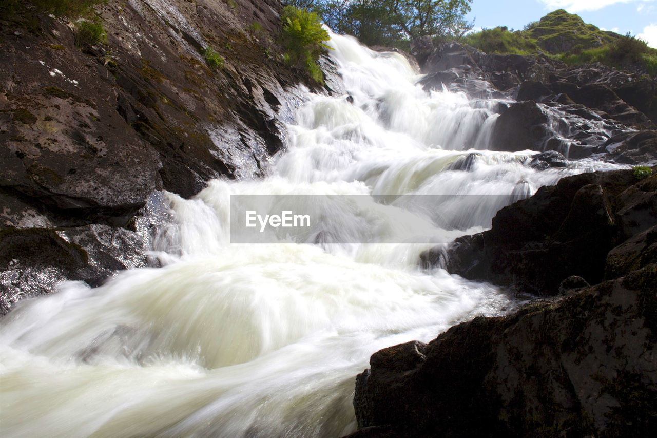 VIEW OF WATERFALL AGAINST SKY