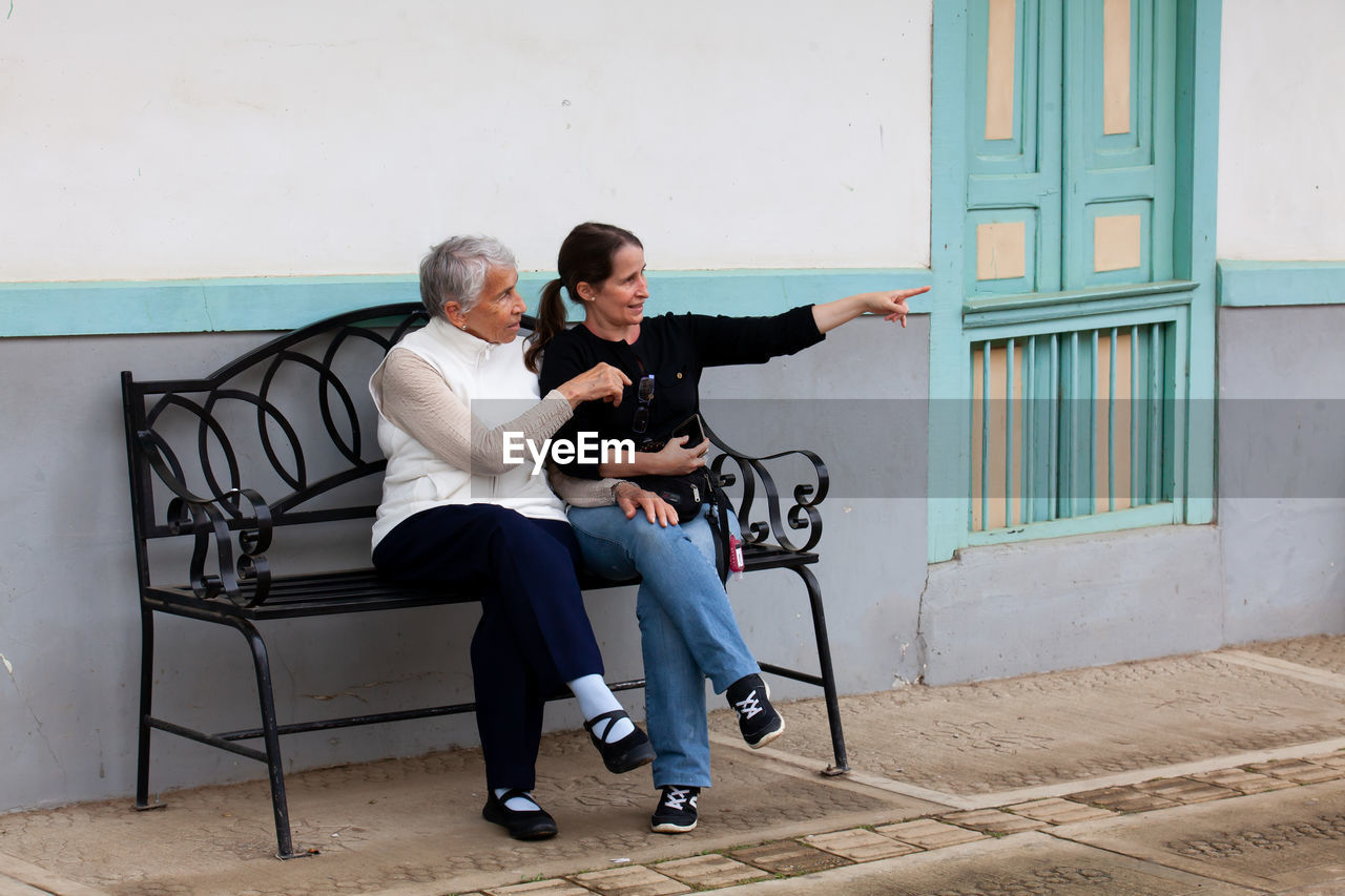 Senior mother and adult daughter traveling together at the small town of salento in colombia