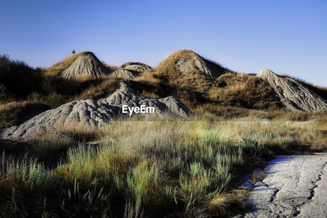 Scenic view of mountains against clear blue sky