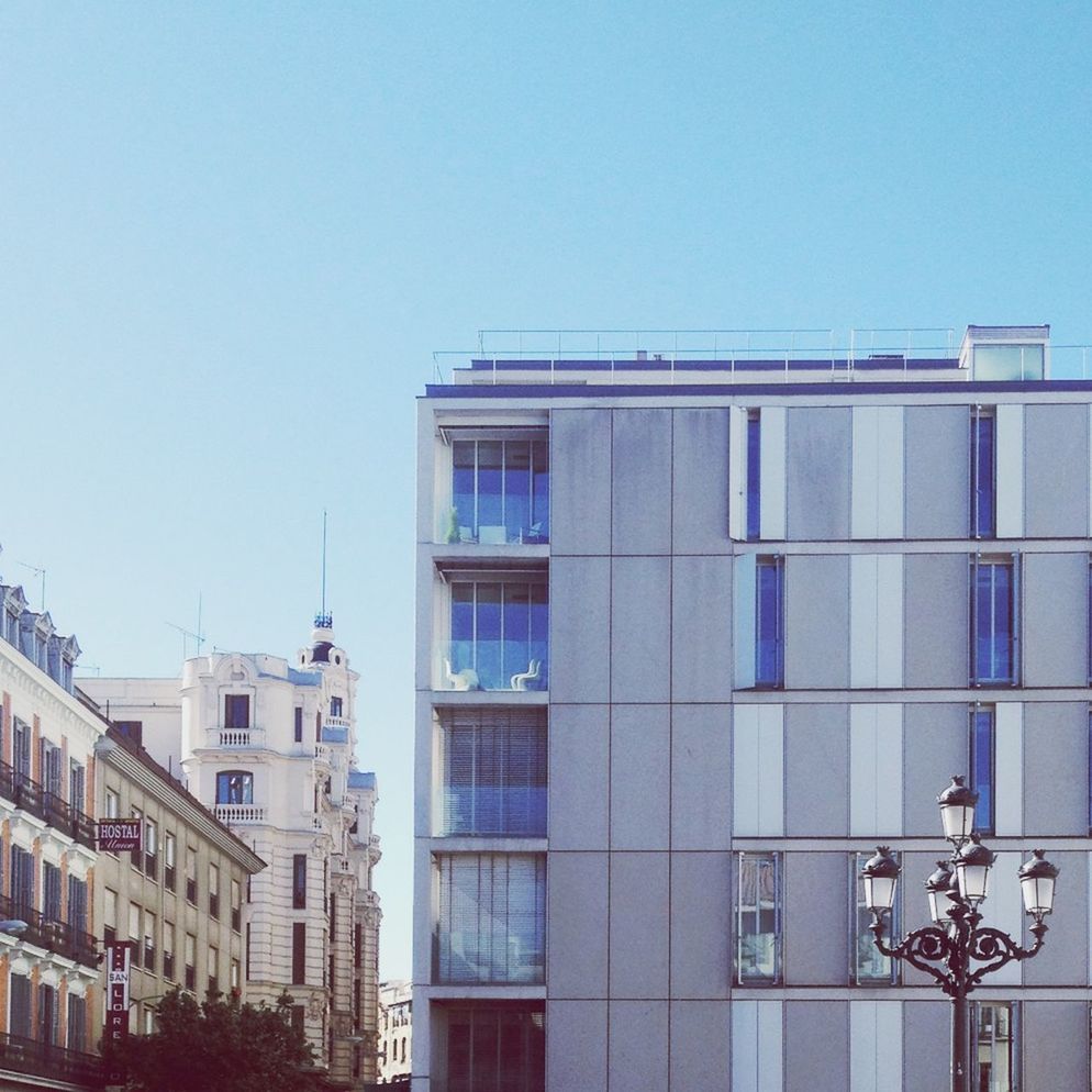 LOW ANGLE VIEW OF BUILDINGS AGAINST CLEAR SKY