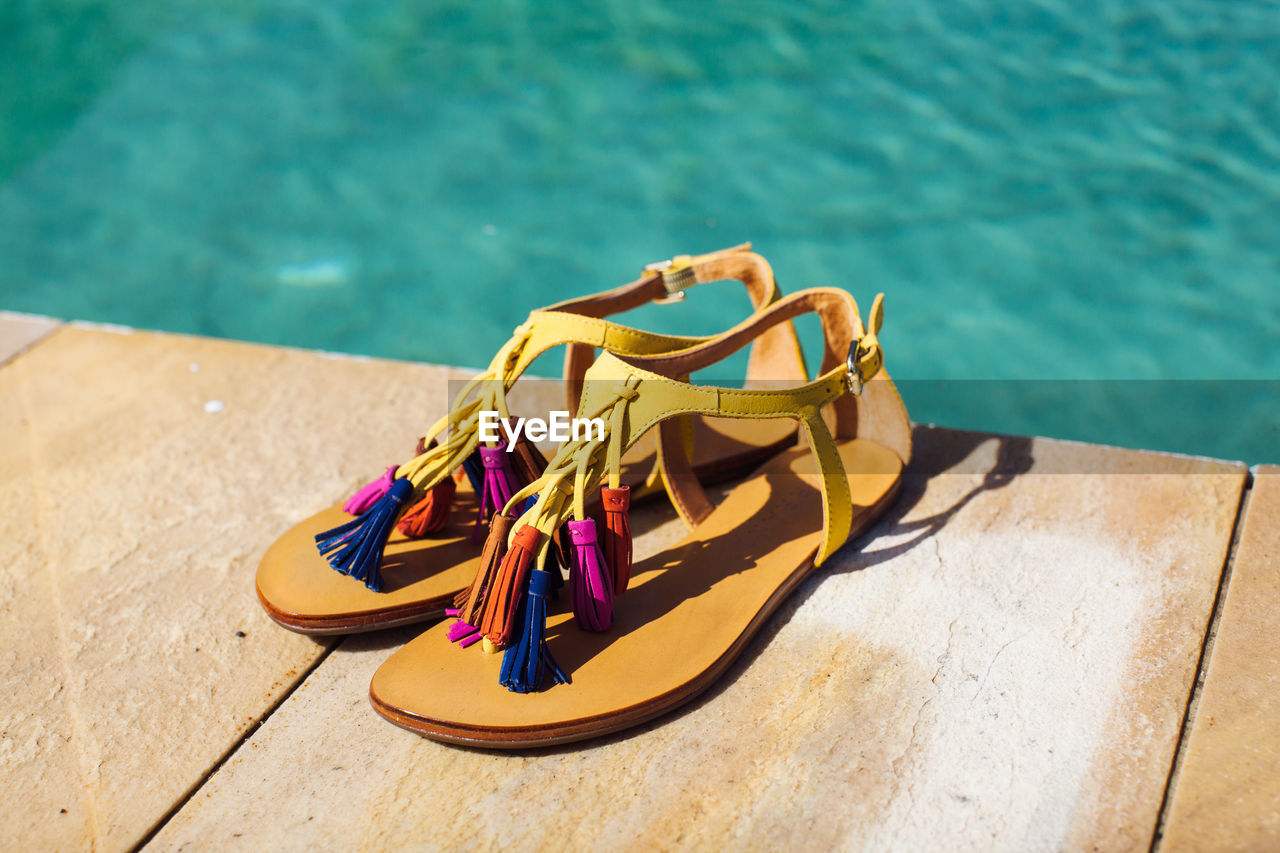 High angle view of shoes on swimming pool against sea