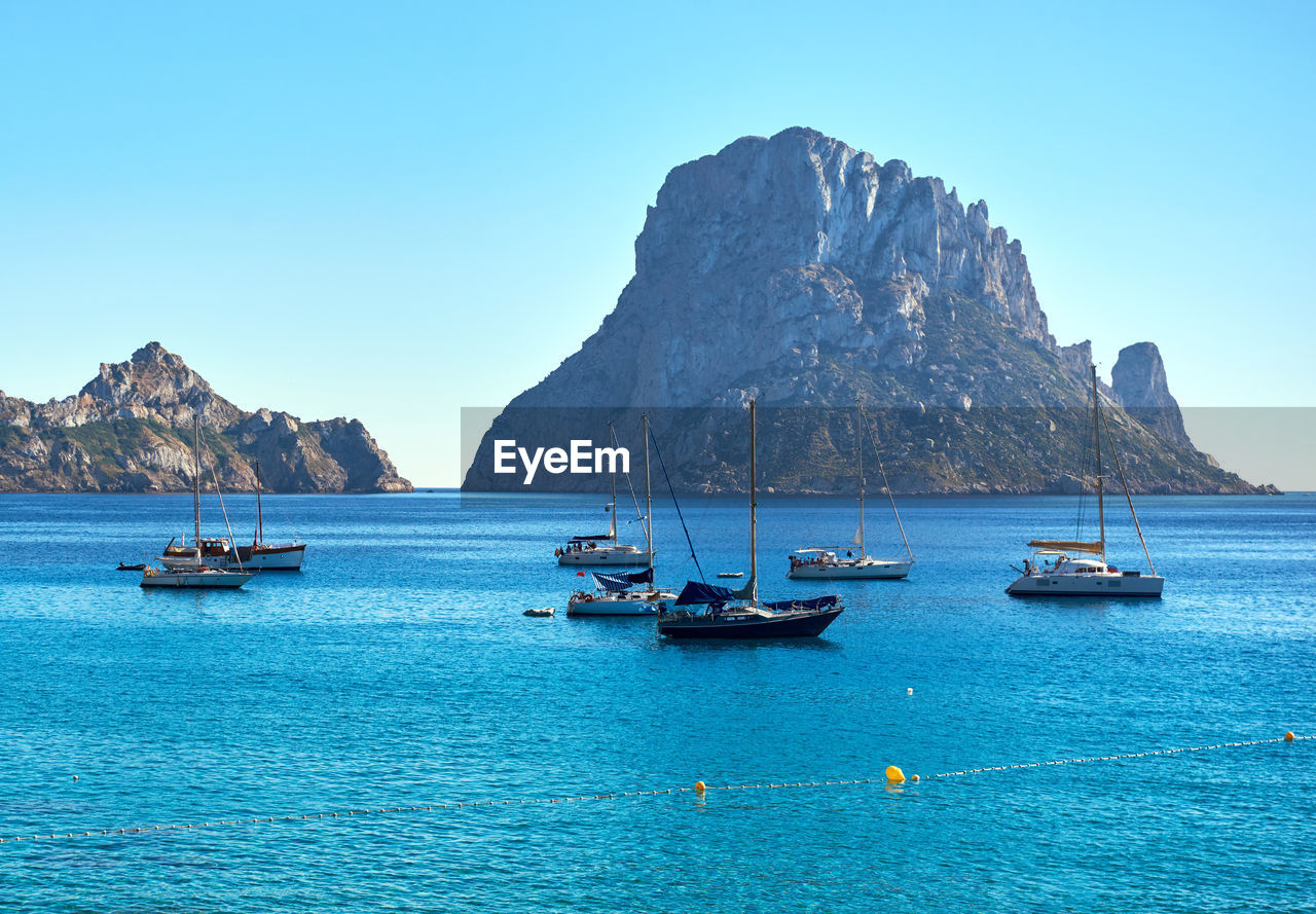 BOATS IN SEA AGAINST CLEAR BLUE SKY