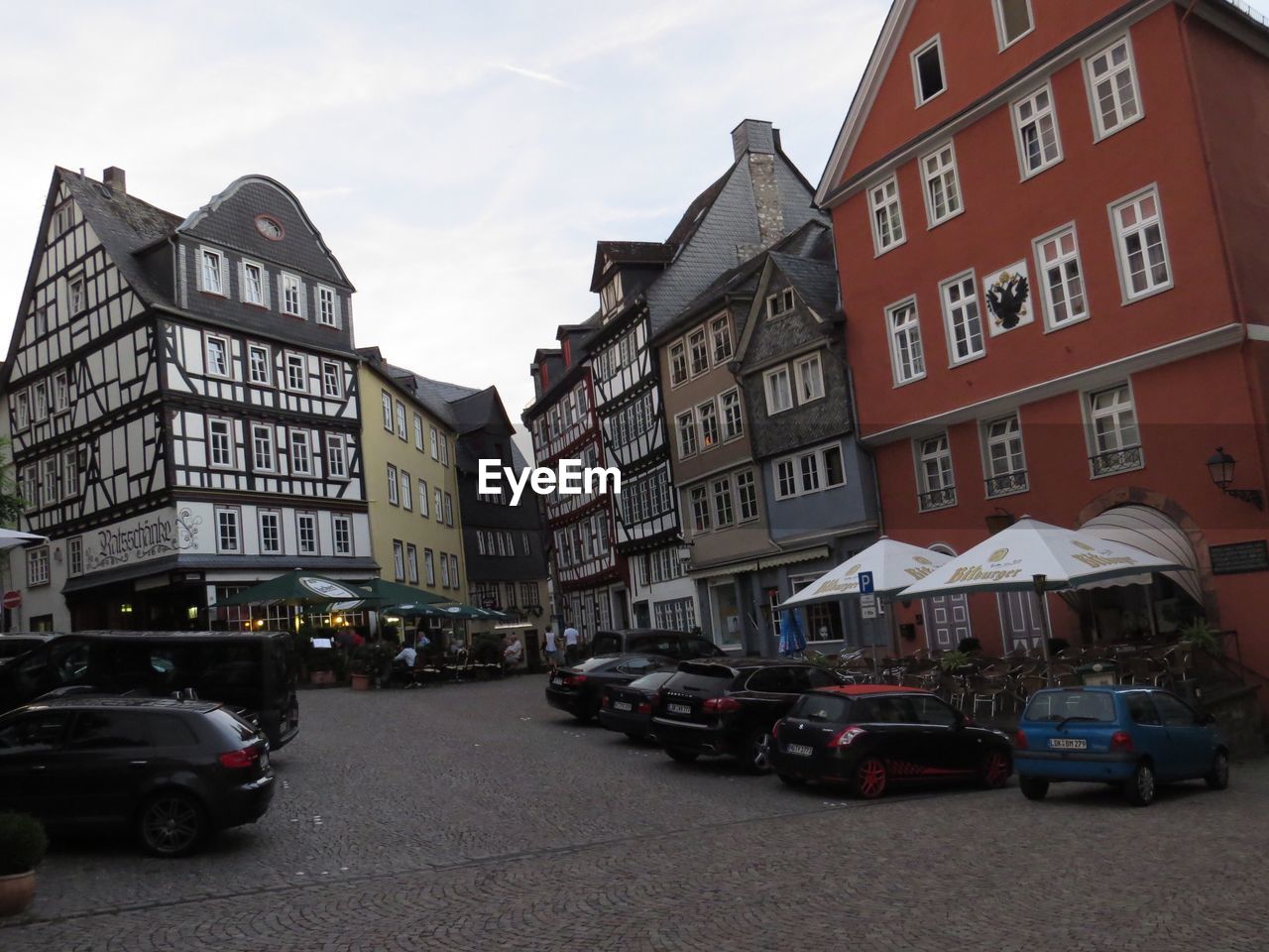 Vehicles on road along buildings