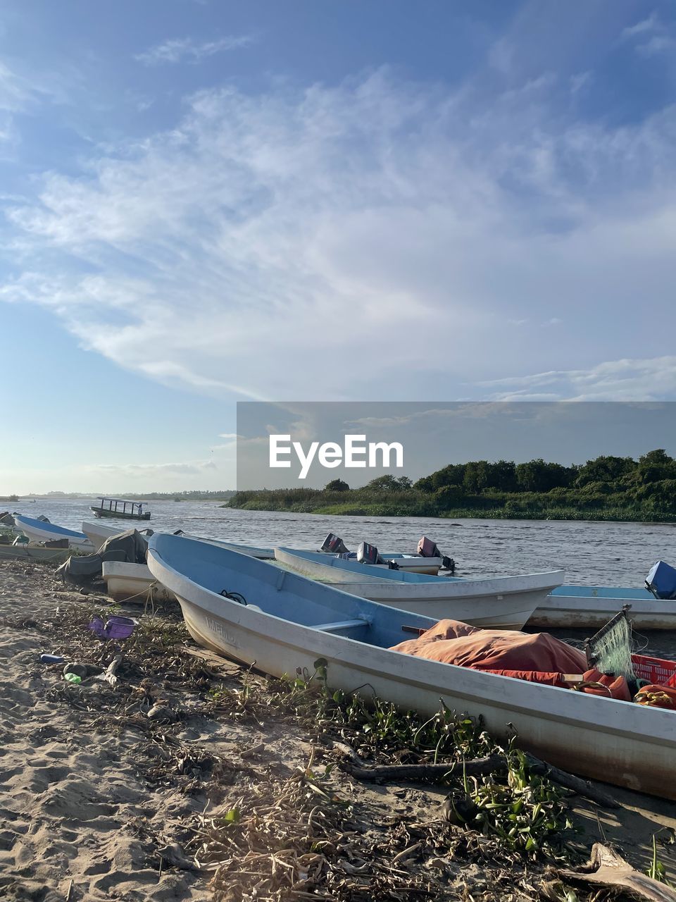 BOATS MOORED ON SEA AGAINST SKY