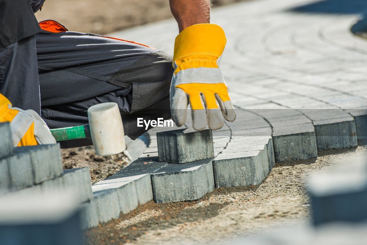 Midsection of manual worker working at construction site