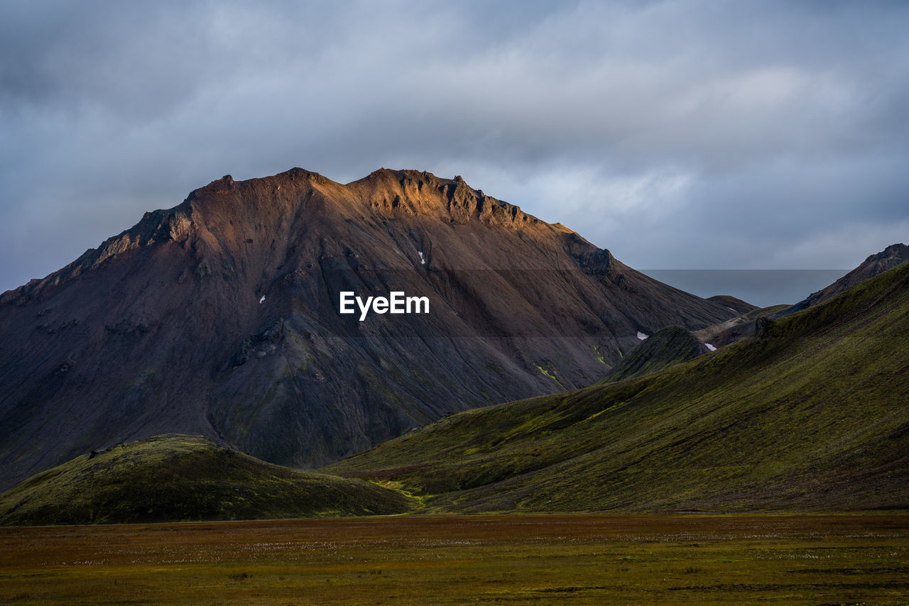 Ray of light touches top of mountain in icelandic highlands
