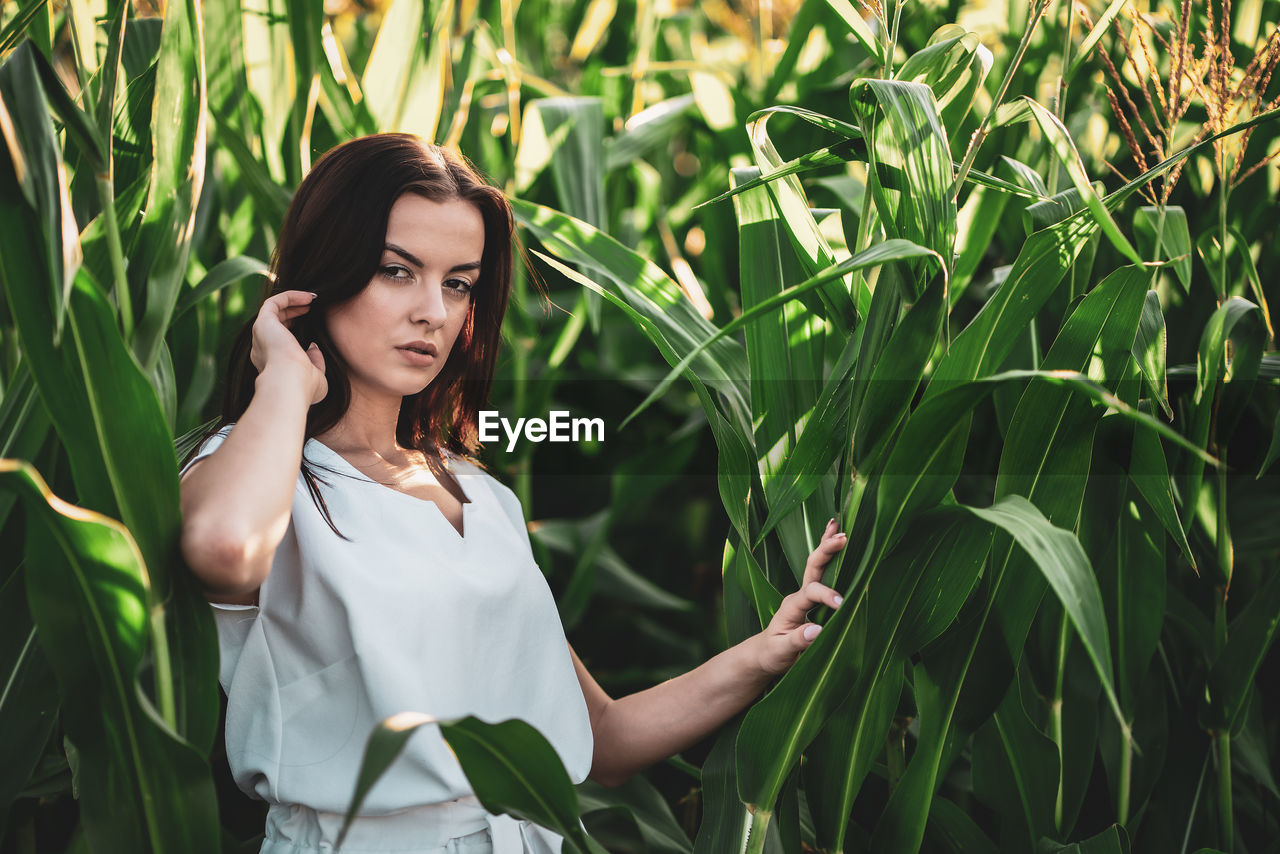 women, plant, one person, adult, green, field, growth, young adult, agriculture, nature, corn, crop, land, cereal plant, rural scene, landscape, female, grass, standing, beauty in nature, looking, portrait, long hair, outdoors, technology, environment, hairstyle, waist up, lifestyles, wireless technology, summer, flower, brown hair, emotion, smiling, person, food, farm, occupation, food grain, telephone, fashion, businesswoman, communication