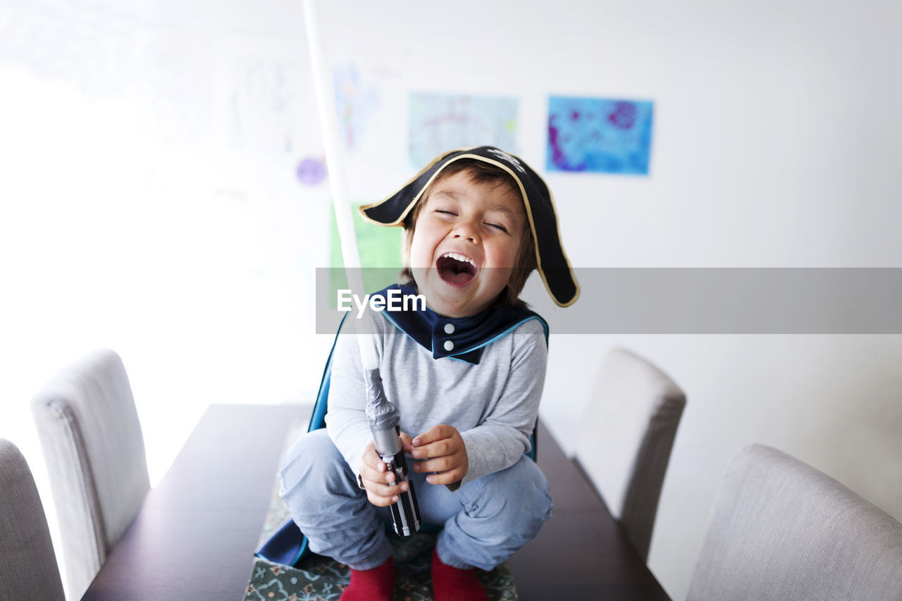 Portrait of laughing little boy dressed up as a pirate