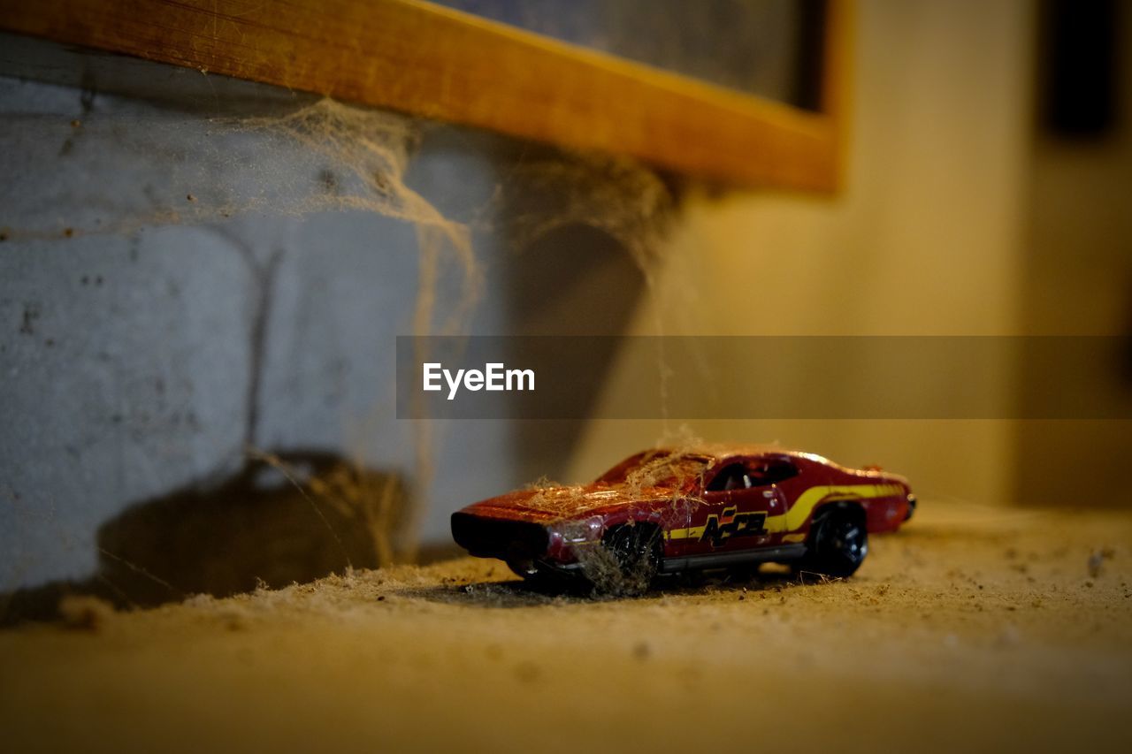 CLOSE-UP OF ABANDONED TOY CAR